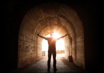 man stands inside of old dark tunnel
