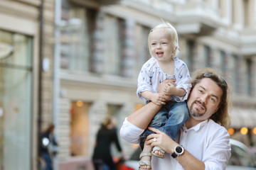 Wall Mural - Young father holding his little girl