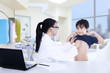 © Creativa Images - Female doctor examining a patient