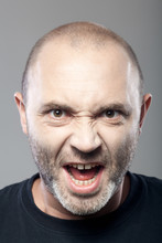 Portrait Of Angry Man Screaming Isolated On Gray Background