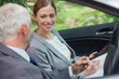 © WavebreakmediaMicro - Smiling partners working together in classy car