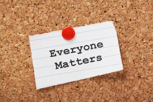 Everyone Matters paper note pinned to a cork notice board