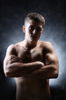 © Africa Studio - Handsome young muscular sportsman, on dark background