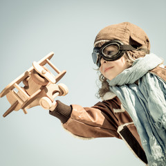 Canvas Print - Happy kid playing with toy airplane