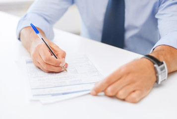 man signing a contract