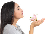 Side View Of An Arab Woman Smelling A Flower