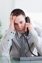 Wall Mural - Depressed businessman on the phone