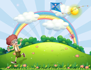 Sticker - A boy playing with his kite at the hilltop with a rainbow