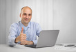 © spaxiax - Businessman with laptop showing thumbs up