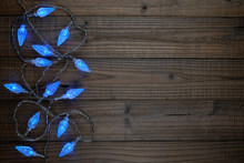 Blue Christmas Lights On Wooden Background