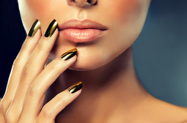 Golden makeup and metal gold nails