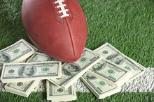 NFL Football On Field With A Pile Of Money