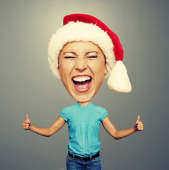 Wall Mural - funny santa girl showing thumbs up