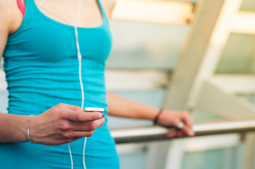 Detail of young woman relaxing outdoors on a modern bridge while