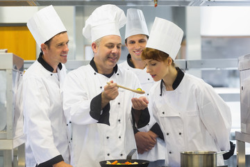 Wall Mural - Senior chef showing food to his colleagues