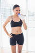 © lightwavemedia - Pleased dark haired model in sportswear drinking water