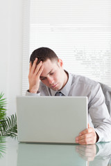 Wall Mural - Close up of disappointed businessman looking at his laptop