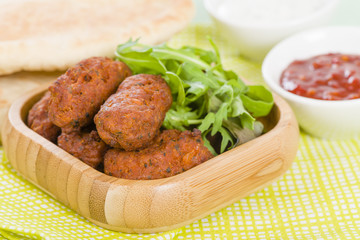 Wall Mural - Koftas - Asian meatballs with salad, pita bread and sauces.