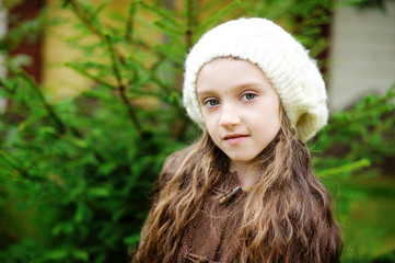 Wall Mural - Child girl in white cap, close-up portrait