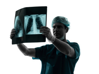 doctor surgeon radiologist examining lung torso  x-ray image