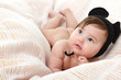© Khorzhevska - cute baby lying on pink plaid in funny mouse hat, beautiful kid'