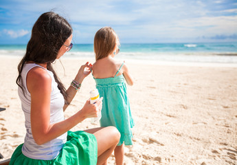 Mother protects her baby from the sun with suncream