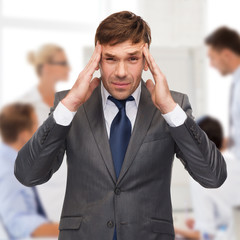 stressed buisnessman or teacher having headache