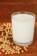 Wall Mural - Soy beans with glass of milk on wooden background