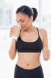 © lightwavemedia - Peaceful dark haired model in sportswear smelling coffee