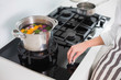 © lightwavemedia - Close up on woman cooking vegetables
