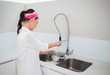 © lightwavemedia - Focused charming woman cleaning dishes