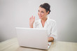 © lightwavemedia - Waving charming businesswoman using laptop