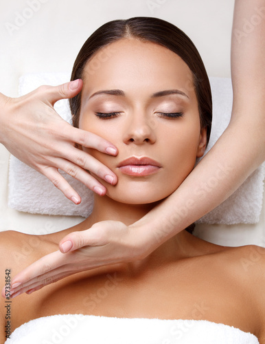 Obraz na plátně Face Massage. Close-up of a Young Woman Getting Spa Treatment.