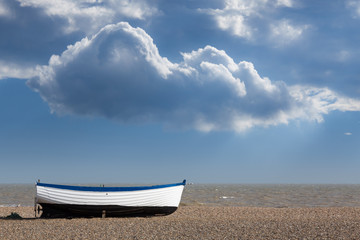 Old fishing boat on pebble beach