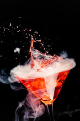 Wall Mural - red cocktail with splash and ice vapor