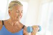 © tmc_photos - Woman Exercising With Dumbbell At Home
