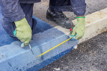 building worker cutting plastic grid 3