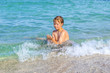 © travelview - boy enjoys the clear water in the ocean