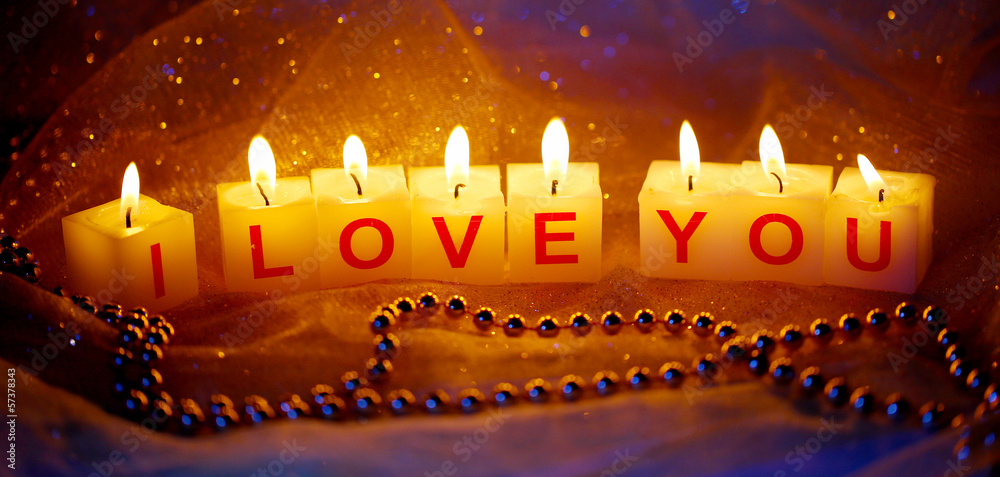 Candles with printed sign I LOVE YOU,on  blur lights background