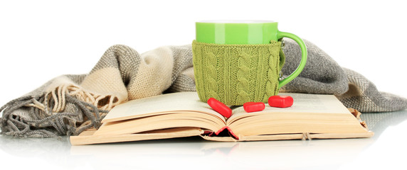 Aufkleber - Cup with knitted thing on it and open book isolated on white