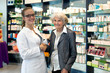 © belahoche - Pharmacist assisting an elderly lady.
