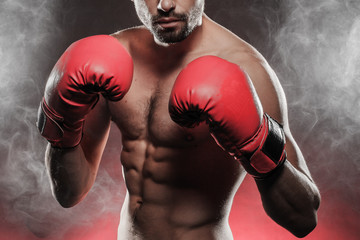 mens torso wearing boxing gloves