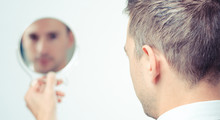 Ego Man Reflection In Mirror On A White Background