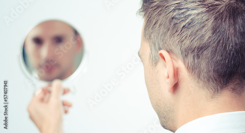 ego man reflection in mirror on a white background Tableau sur Toile