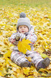 lovely baby with yellow leaf outdoors