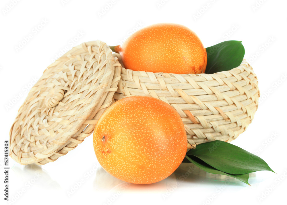 Passion fruits in wicker basket isolated on white
