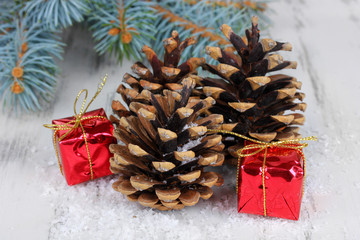 Wall Mural - Christmas decoration with pine cones on wooden background