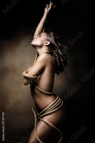 Fototapeta na wymiar young woman wrapped in rope