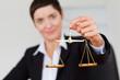 © WavebreakMediaMicro - Serious businesswoman holding the justice scale
