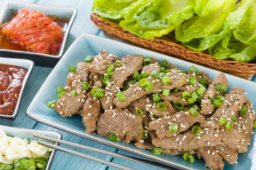 Wall Mural - Bulgogi - Korean grilled beef with side dishes and lettuce